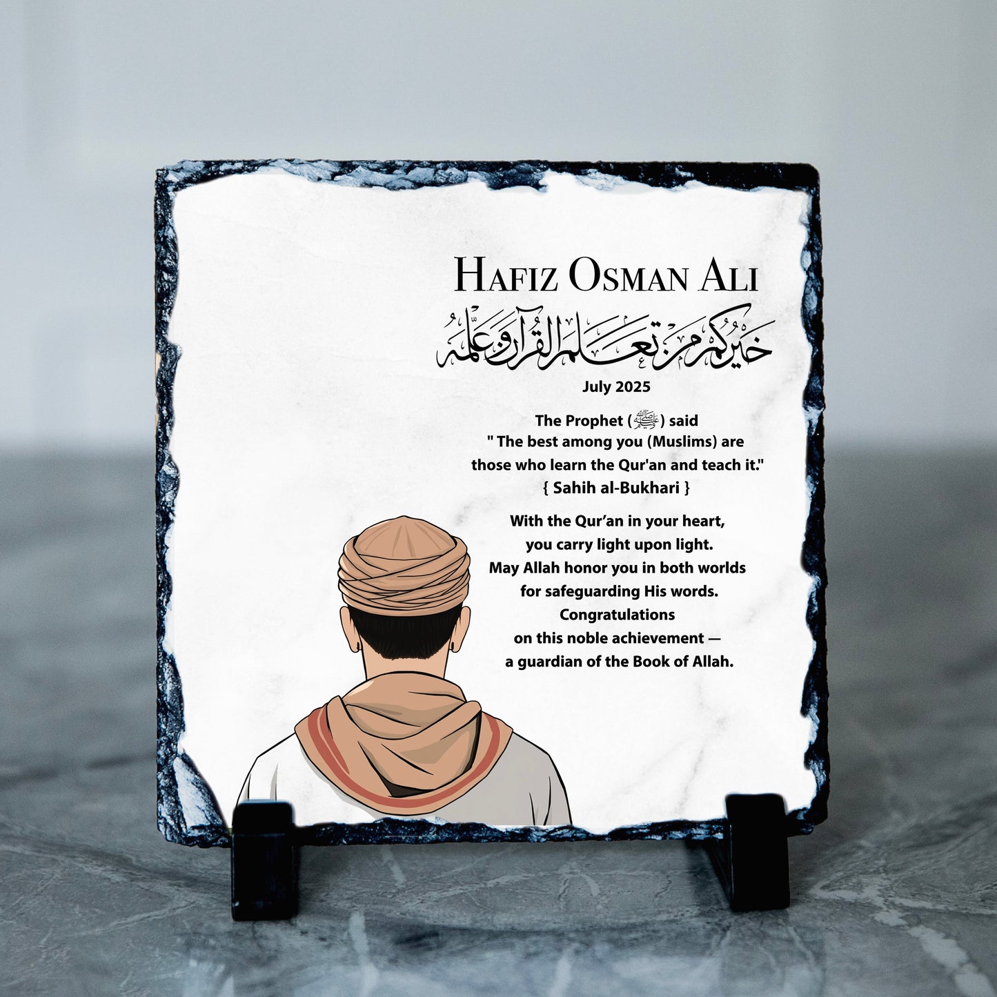 Personalised plaque with printed text and a portrait of a person wearing a headscarf on a slate surface.
