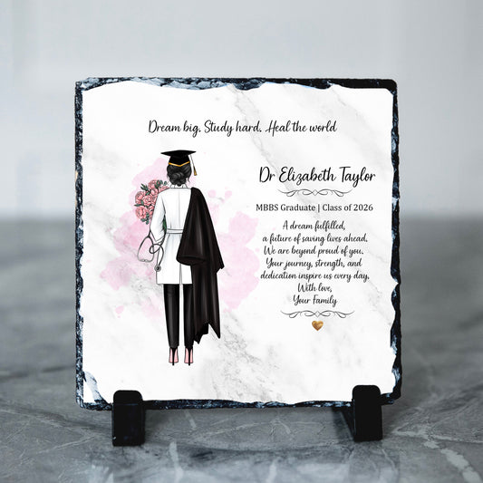 Graduation-themed slate plaque with a graduate illustration and personalized text on a gray background.